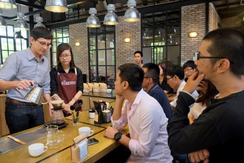 Will Frith (L) runs an impromptu barista training at Workshop, the newest and most prominent coffee-bar in Ho Chi Minh City